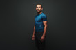 Choosing the right direction. Handsome african american sportsman standing over dark background