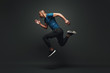 © Friends Stock - Jump higher! Sportsman jumping over dark background