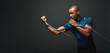 © Friends Stock - Go! Sportsman working out with resistance band over dark background