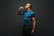 © Friends Stock - Hydrating. Muscular sportsman drinking water after training