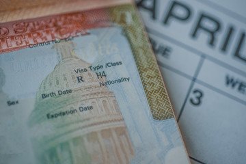 an h-4 visa (immediate family members of the h-1b visa holders) stamp in passport on blurred april c