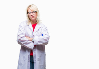 Poster - Young beautiful blonde professional woman wearing white coat over isolated background skeptic and nervous, disapproving expression on face with crossed arms. Negative person.