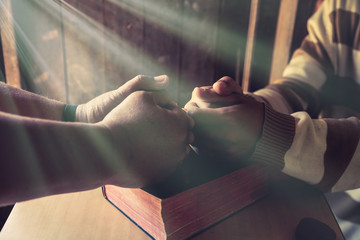 group of different men praying together, color filter added.