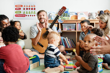 Nursery children playing with musical instruments in the classroom