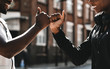 © Rawpixel.com - Friends greeting with a signature handshake
