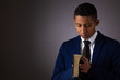 Hispanic Teenager Boy Seeking to Commune with God Via Prayer and Holding the Holy Bible.