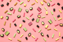 Colorful Lollipop And Licorice Candy On Pink. View From Above. Concept Banner For Design. Flat Lay.