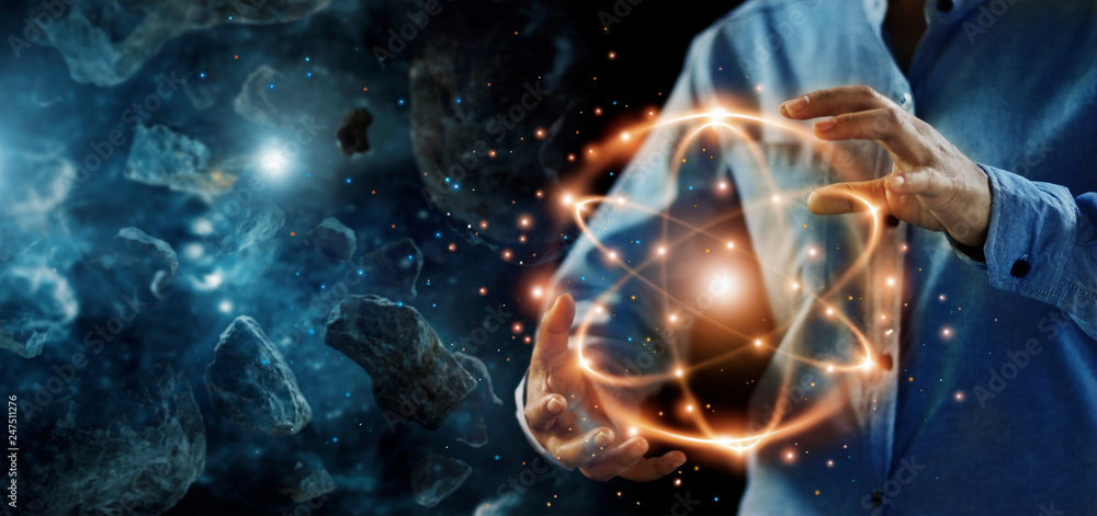 .Abstract science, hands holding atomic particle, nuclear energy imagery and network connection on meteorites space planets background. - obrazy, fototapety, plakaty 