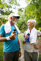 Wall Mural - Mature couple jogging and running outdoors in nature