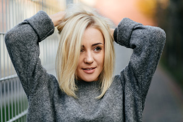 Portrait of a young beautiful blonde girl walking on the streets