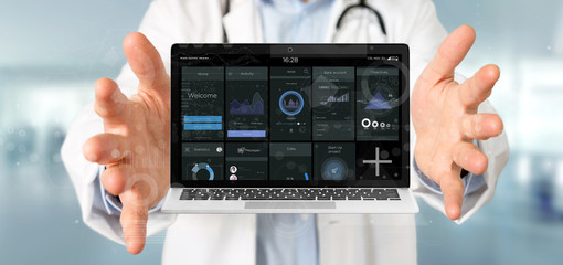 Doctor holding Laptop with business user interface data on the screen isolated on a background