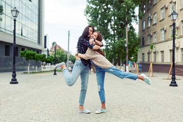 Wall Mural - Carefree smiling sisters hugging and having fun together