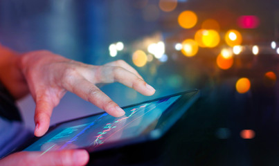 Poster - Stock market. Businessman using a mobile device to check market data and currency exchange rates on colorful background.