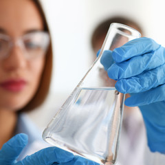 Female technician arms in protective gloves hold