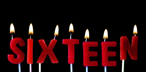 Sixteen spellt out in red birthday candles against a black background