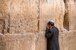 Believing Jew is praying near the wall of crying