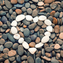 Heart Of Stones On A Background Sea Pebbles. Toned Image