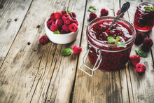 Homemade Raspberry Jam In Two Jars With Raspberries And Mint
