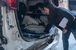 © Amnatdpp - Women are checking cars for accidents