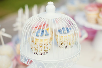 cupcakes with cream and flower decorations