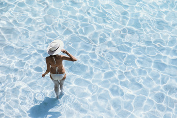 Young beautiful woman standing in the sea and enjoying summer. Summer fun, vacation, holidays, enjoy life concept