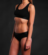 © Bas - sexy Fitness body in sport underwear on black background