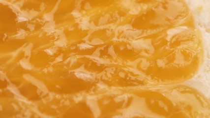 Wall Mural - sliced ripe orange fruit rotating. Closeup macro shot. Fresh berry series.