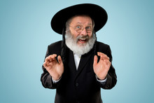 Portrait Of Old Senior Orthodox Hasdim Jewish Man With Wooden Grager Ratchet At Jewish Festival Of Purim At Studio. The Purim, Jewish, Festival, Holiday, Celebration, Judaism, Pastry, Tradition