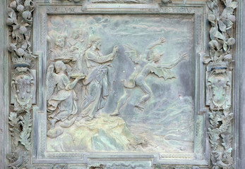 Wall Mural - Jesus Christ tempted by Devil in the desert, sculpture work from Giambologna's school, collocated in the left portal of the Cathedral St. Mary of the Assumption in Pisa, Italy