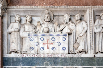 Wall Mural - Detail of the bas-relief representing the Stories of St. Martin; preserved in the Portico of the Cathedral of St. Martin in Lucca, Italy