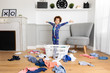 © Lisa Tichané - Playful boy in pajamas making mess with laundry basket