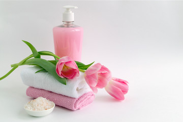 Liquid soap and two towels on a white background.