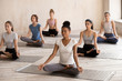 © fizkes - Diverse calm female yogi meditate in lotus position together