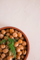 casserole of chick-peas cooked on white fund.boiled chickpeas in a clay pot close up. copy spase.Boiled chickpeas in a bowl.traditional Turkish cuisine