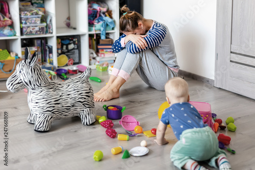 Tired Of Everyday Household Mother Sitting On Floor With