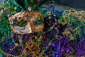 Wall Mural - mardi gras mask and beads in green, gold, and purple