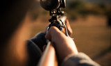 Hunter with shotgun gun on hunt. Hunting Gea. Hunting Supplies and Equipment - copy space.
