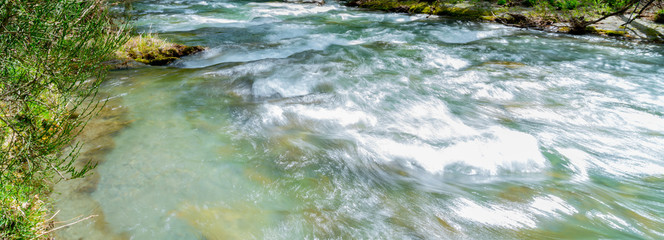 Wall Mural - Arrow River flowing through gorge lined with deciduous trees.