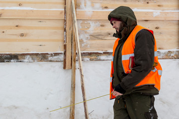 Portrait of an assembler with a tape measure in the hands of