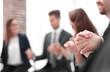© ASDF - Business group in a circle holding hands indoors