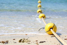 Line Of Yellow Buoys Against The Blue Sea.