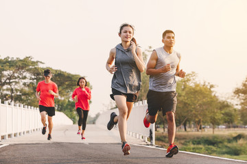 young people runner running on running road in city park