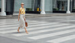© LUMINA IMAGES - Beautiful elegant confident businesswoman walking on the street carrying a purse.