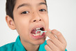 © wckiw - Little boy using dental floss to clean tooth