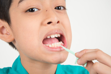 Poster - Little boy using dental floss to clean tooth