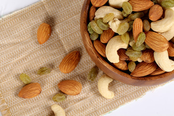 Wall Mural - ssorted nuts on white, dry fruits, mix nuts, almond, cashew,  raisin