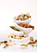 Wall Mural - ssorted nuts on white, dry fruits, mix nuts, almond, cashew, pistachio, raisin