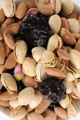 Wall Mural - Assorted nuts on white, dry fruits, mix nuts, roasted almond, prunes, pistachio