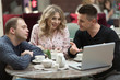 © Make_story Studio - Group of 3 young business people gathered together at a table discussing an interesting idea in the cafe