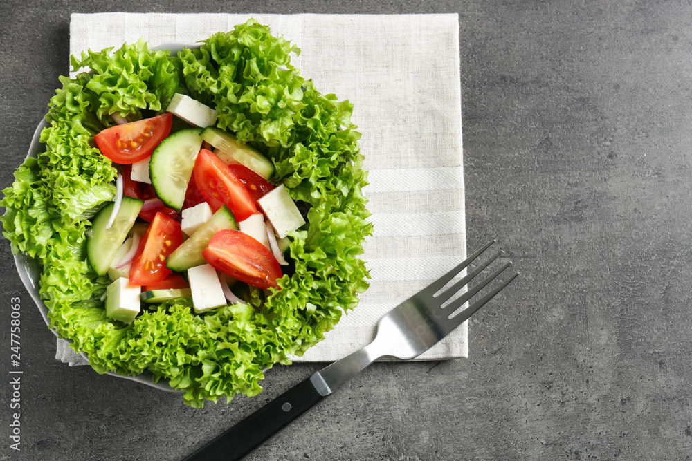 Plate with fresh vegetable salad on table. Diet food